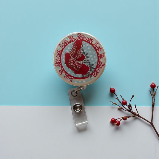 Retractable badge holder with red boot design on a blue and white background